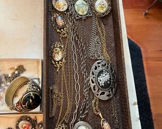 Hand painted porcelain medallion necklaces, brooch, rings.