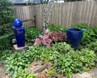 #55 - $150 Blue fountain with pinecone 13x13x36 and #56 $80 Blue squarish planter 16x16x22H (Right of fountain)