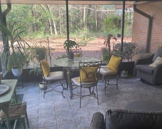 Wrought iron table and chairs w/ glass top. 
Seats are covered for outdoor protection. 