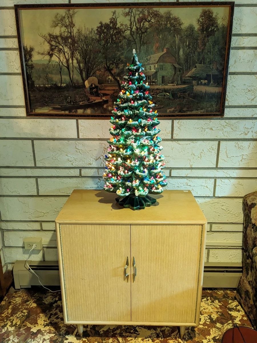 The LARGEST ceramic Christmas tree I have EVER seen!  2 ft. 9 in.  Some of the lights are birds. The cabinet is a lane cedar 'hope cabinet'.