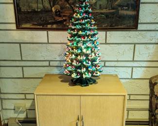 The LARGEST ceramic Christmas tree I have EVER seen!  2 ft. 9 in.  Some of the lights are birds. The cabinet is a lane cedar 'hope cabinet'.