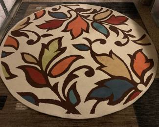 Round rug with colorful floral pattern, ideal for a kitchen nook.