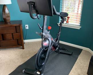 Peloton bike. Upgraded to new screen/processing unit a couple years ago, bike is 1st generation peloton. Includes spare replacement pedals, weights and mat.