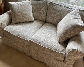 F130 - $75. Loveseat by Work Bench. Currently has a slipcover on it with a stain - easy to wash! 61" wide, 35" deep, 20" to seat, 32" to back.