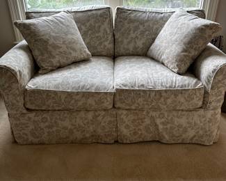 F130 - $75. Loveseat by Work Bench. Currently has a slipcover on it with a stain - easy to wash! 61" wide, 35" deep, 20" to seat, 32" to back.