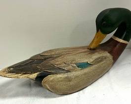Vintage Signed Carved Wood Decorative Mallard Duck Decoy by Lou Schifferl.

Fine hand carved and painted wood Mallard (Drake) duck decoy with glass eyes. 

 Measures 17.5 inches in length. 