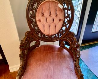 there are two of these chairs with pink velvet and lovely floral woodwork