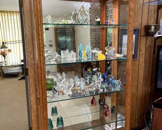 This beautiful solid wood and glass display case has 5 shelves and is an impressive piece.  Side doors open for access.