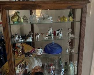 This showcase contains, vintage animals, art glass, Trolls, and Military items