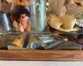 Military items are on the bottom shelf, also a Boatswains Whistle and Boy Scout badges. Vintage brush items