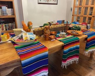 Dining table with Mexican Serape blankets, sugar mold, copper pieces, Japanese luster ware, ceramics, Fiesta mugs and pitchers