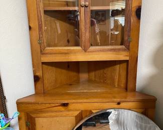 Vintage maple corner cabinet with glass top doors, solid door at the bottom, great storage and display piece. This piece is in the bedroom
