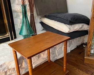 Accent table, large cushions, tall green glass vase with twig arrangements, original art piece