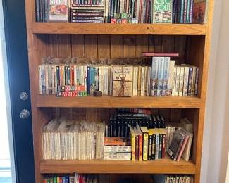 This bookcase contains vintage Louis L'Amour paperbacks, Rex Stout, Agatha Christie, Children's Horizons