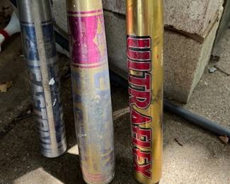 On the right is a Worth Ultraflex slow pitch softball bat.