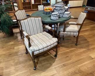 Round wood pedestal dining table; striped upholstered armchairs on casters, set of 4 chairs available