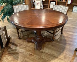 Round wood pedestal dining table; striped upholstered armchairs on casters, set of 4 chairs available