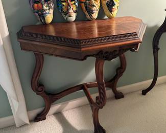 Three-sided, decorative carved wood accent table with claw feet 
