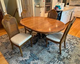 Nichols & Stone oak with iron pedestal dining table, and 4 armless chairs with cane backing
