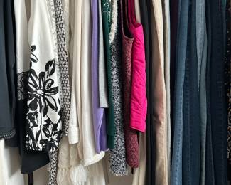 One of several closets filled with beautiful clothing.