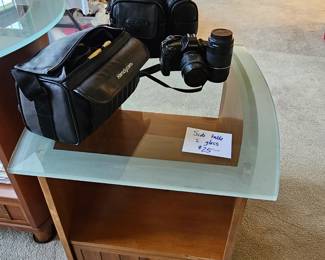 $25 Glass & wood End table, $75  Cannon Camera, $12 Cannon lens
