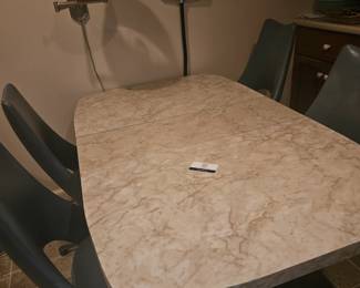 Located in kitchen includes 4 chairs. Leaf is already in it.