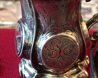 A small finely etched English silver mini pitcher.