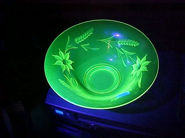 Drop dead gorgeous etched Vaseline glass piece under a black light.