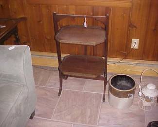 A folding shelving unit, a Crock, and a lantern.