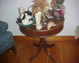 A vintage round table with assorted items.