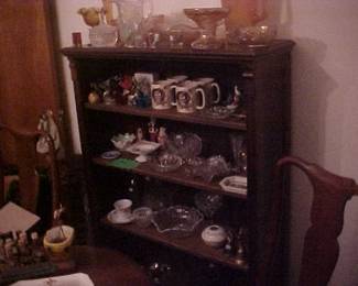 Another shelving unit full of carnival glass, bird figurines, Otagiri owl mugs, pink depression glass, a hair receiver, cups and saucers, copper glasses, shot glasses, and lots of other great items.