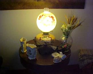 Vintage round table and an electric lamp and other odds and ends.