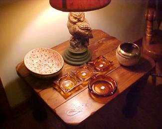 Owl lamp, amber ashtrays, bowls and a heavy wooden end table.