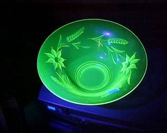 Drop dead gorgeous etched Vaseline glass piece under a black light.