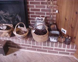 Baskets, a large ceramic electrical insulator, a fireplace set, a large plush owl, and a stool.