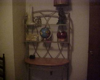 A beautiful metal, glass, and wood shelving unit.