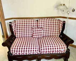 Wooden loveseat w/ red & white checked cushions