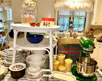 Corning ware, stoneware dishes and nest of 3 mixing bowls, stoneware canister set, Kitchen Aid heavy duty mixer w/ a box of many attachments (SOLD), Seyferts Butter Pretzels glass jar, woven side table