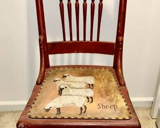Antique chair painted red with sheep on seat