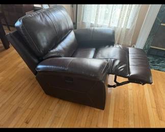 Electric recliner leather-like chair. Minimal clearance needed from wall.