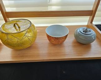 35. (Left) Ono Hakuko 1925- 1966
Squat lidded vessel glazed porcelain
5 1/8 x 6 3/4 diameter
36. (Center) Ono Hakuko red teabowl
4 5/8 x 3
37. (Right) Kawase Shinobu stoneware Caledon glaze 4 3/8 x 3 1/8