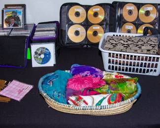 Various CDs and DVDS, colorful fashion scarves