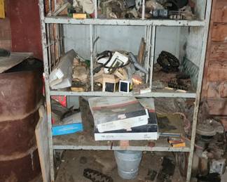 Larege metal shelf with many unusual parts and items