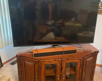 . . . nice TV stand and large flat-screen TV and sound bar