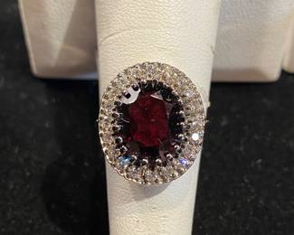 14kt oval garnet ring with 20 round diamonds.