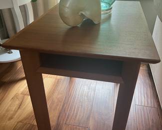 One of two teak lamp tables