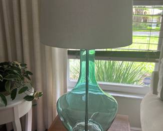 One of two glass base table lamps