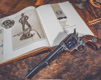 Colt Texas Rangers Commemorative SAA Revolver W/ Ranger Signed Book. Marked: "One Riot...One Ranger" on left side of barrel; "TEXAS RANGERS" on the backstrap; "YO" brand on bottom of grip frame.