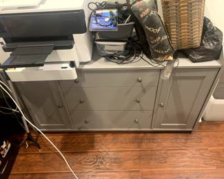 Office furniture including a dresser, multiple file cabinets, desktops and accessories. 