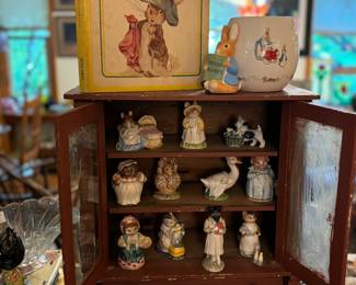 Cute antique cabinet, peter rabbit book and vase
